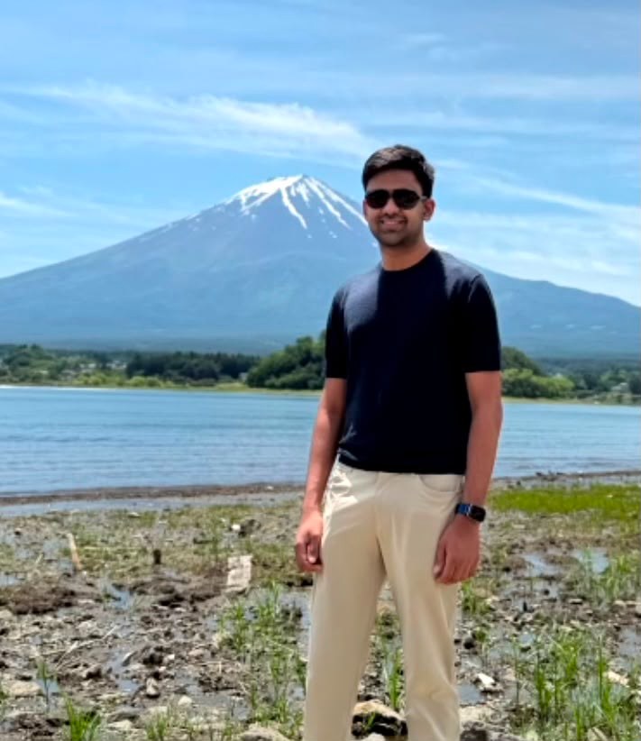 Pranav posing in sunglasses in front of Mount Fuji