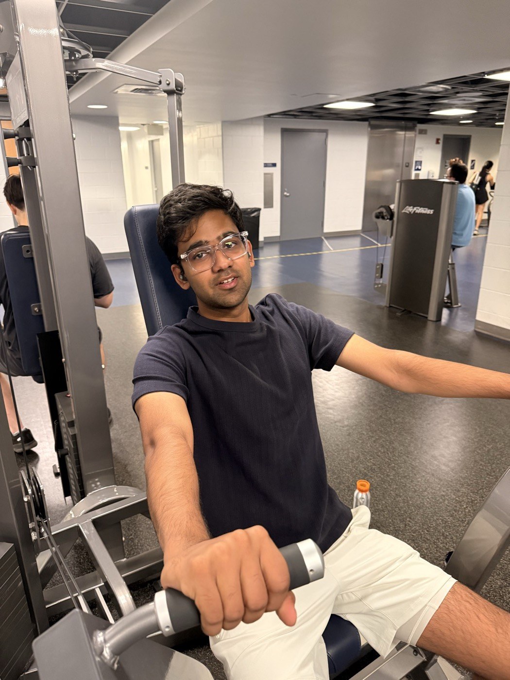 Pranav posing on a gym machine