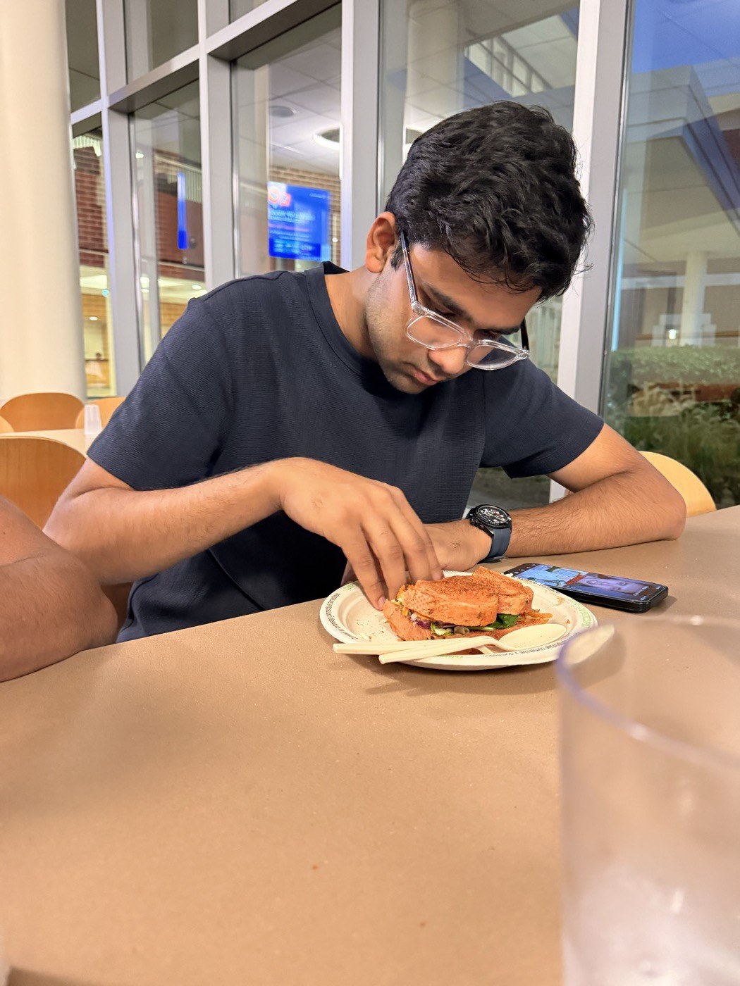 Pranav examining a sandwich very closely